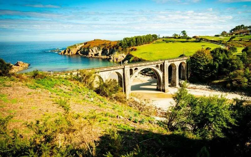 A bridge connecting two stretches of land above a beach