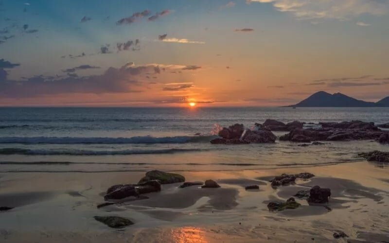 A beautiful sunset at the sea as seen from a beach