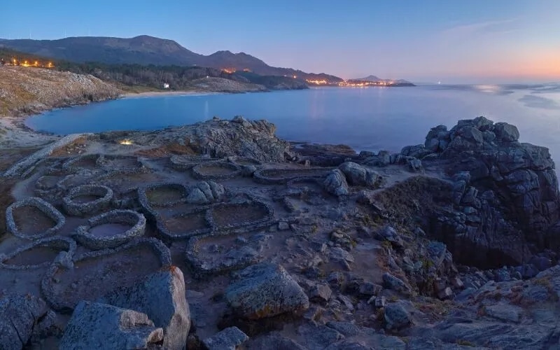 Some ruins in front of the sea at sunset