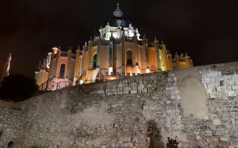 An old wall and a cathedral in the background