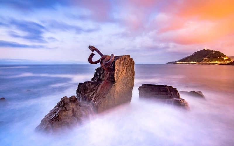 Steel sculptures rising among the waves and clouds