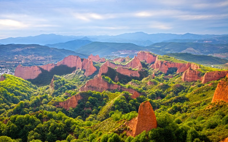 Red cliffs rising from a forest area