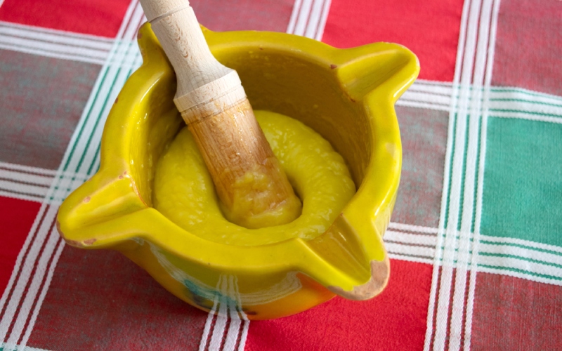 A mortar with yellow aioli