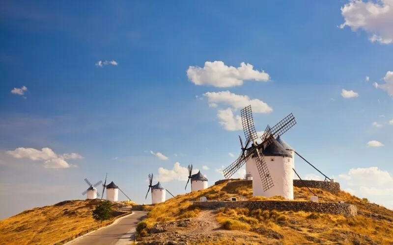 White windmills and a blue sky