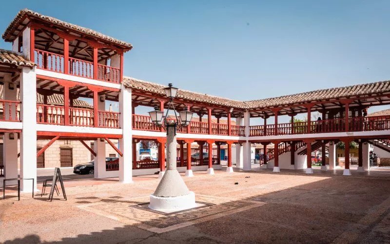 A town square with a structure resembling a traditional Spanish theatre