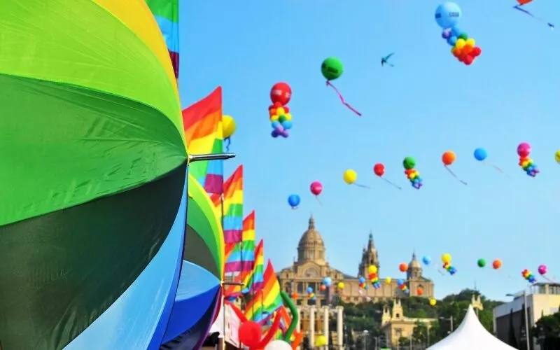 A view of colourful rainbow umbrellas and balloons 