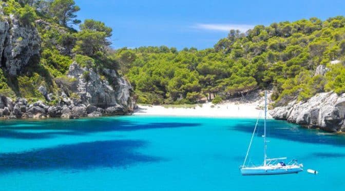 A beautiful cove with blue water and pine trees