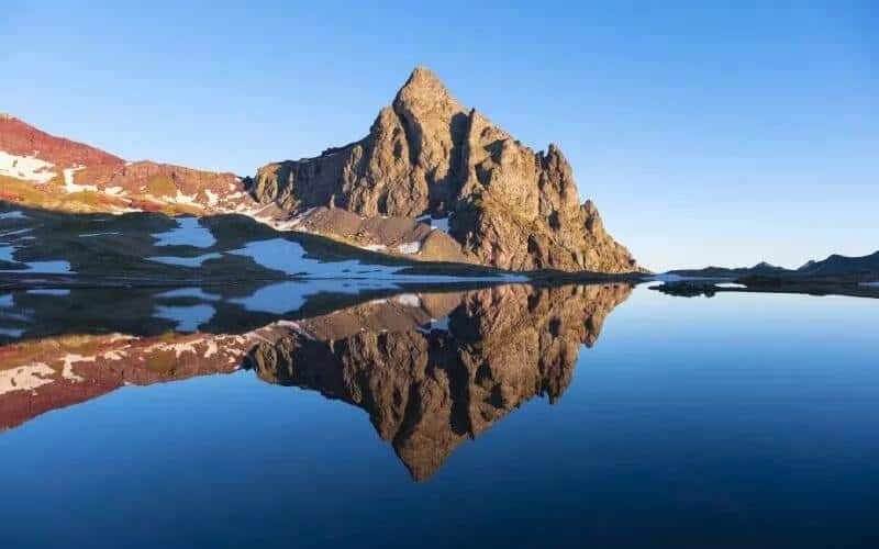 A rocky peak reflecting on a lake