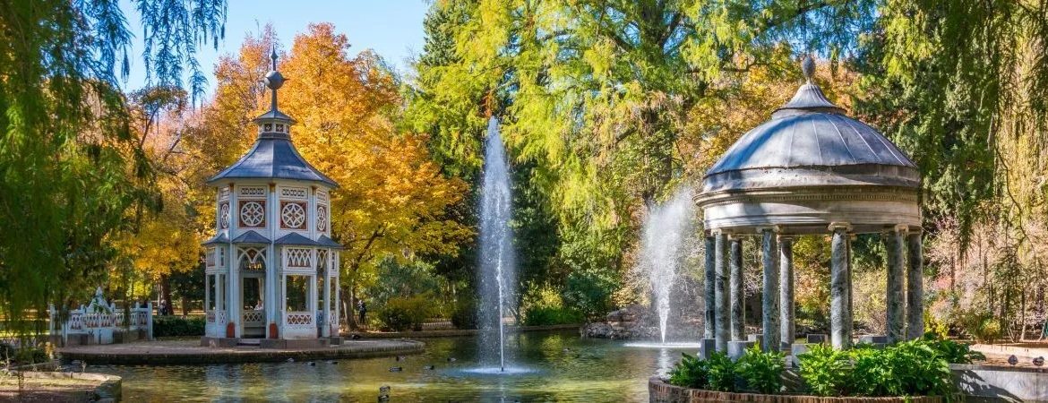 A beautiful garden with fountains and colourful trees