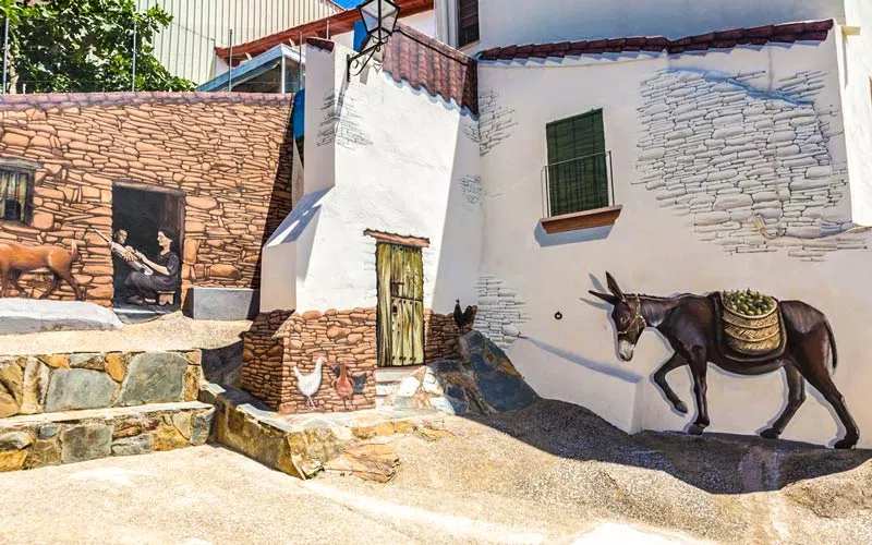 Mural paintings with images of animals and peoples in a village