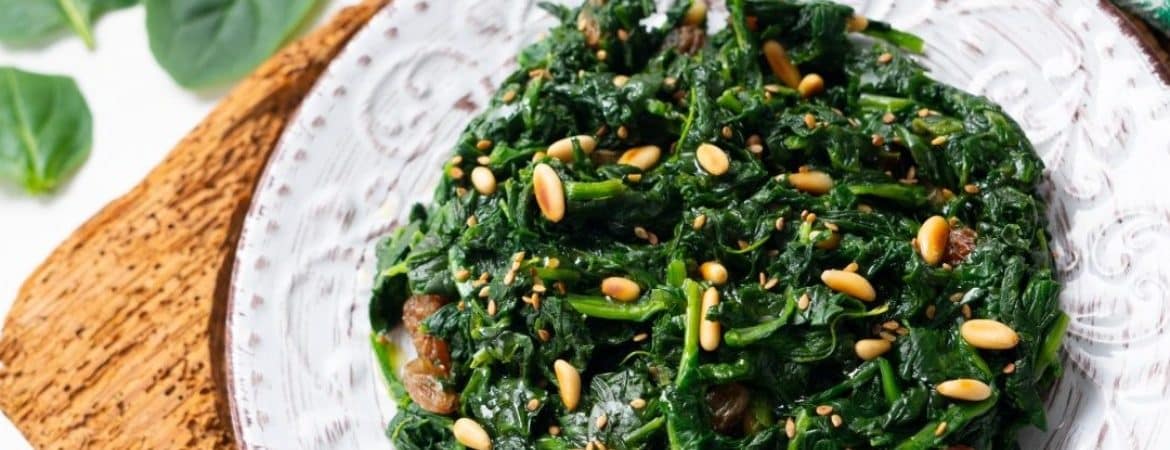 A dish with spinach, pine nuts and raisins
