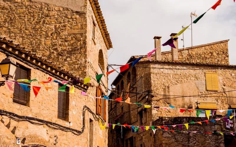 A medieval street decorated with colorful flags